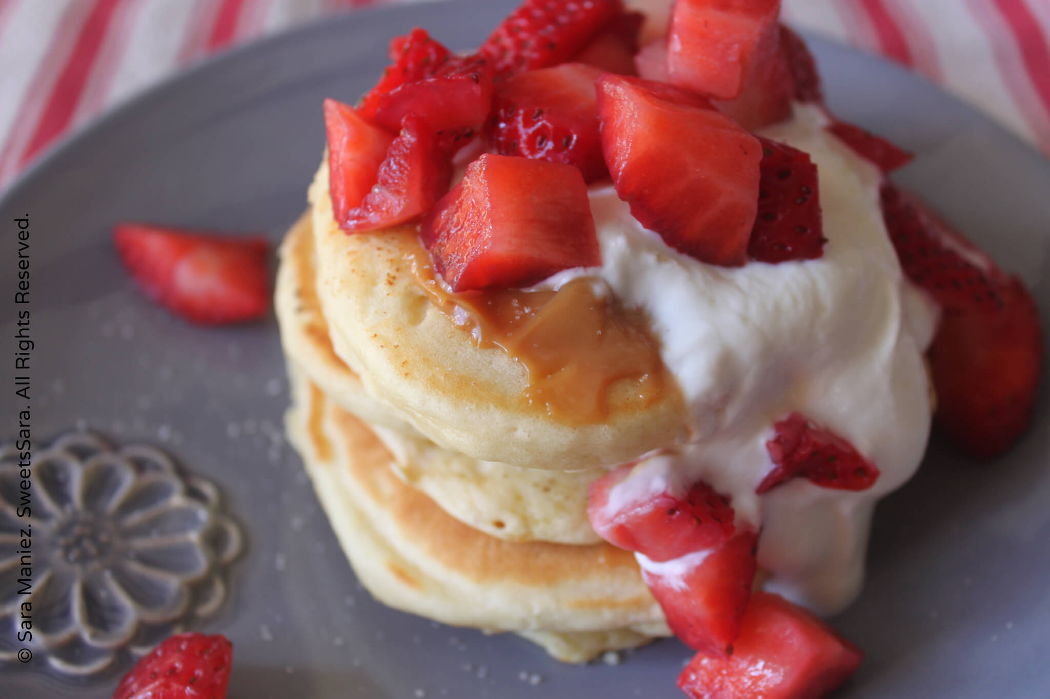 Strawberry Buttermilk Pancakes: These buttermilk pancakes are thick, fluffy, moist, cake-like pancakes. They work well with fresh strawberries in the batter, on top only or both. Dulce de Leche is another flavor component in this assemblage that provides a smooth, caramel punch of sweet and it compliments the Greek yogurt well. #pancakes #buttermilk #strawberries #brunch #breakfast #Greekyogurt