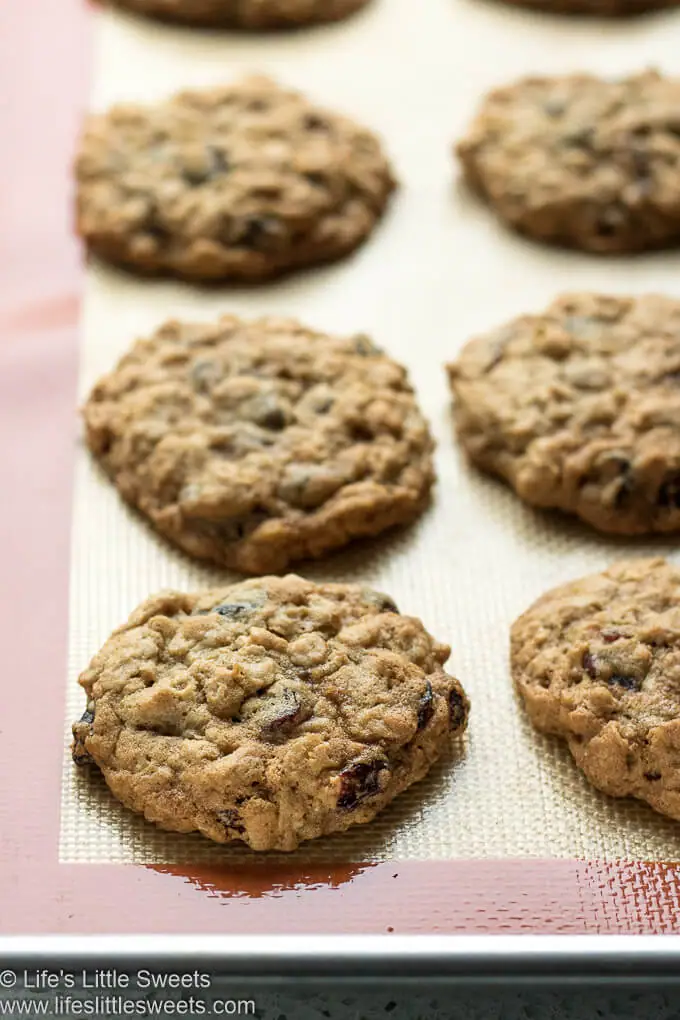 Oatmeal Raisin Cranberry Cookies cooling on a baking mat