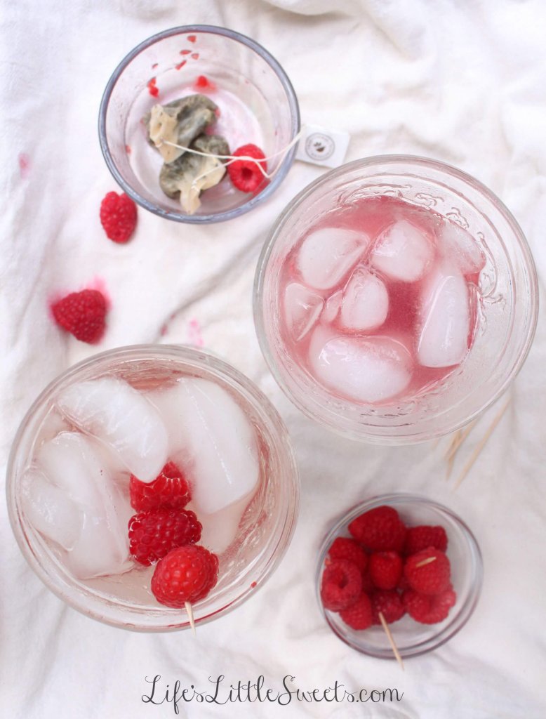 Sipping Cold-brewed Smashed Raspberry Honey Iced Tea overhead view of iced tea with raspberries