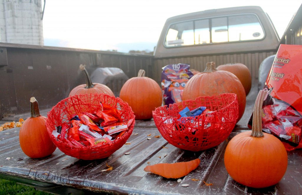 DIY Halloween Treat Bowls on the back of a pick up truck with candy in them and with pumpkins