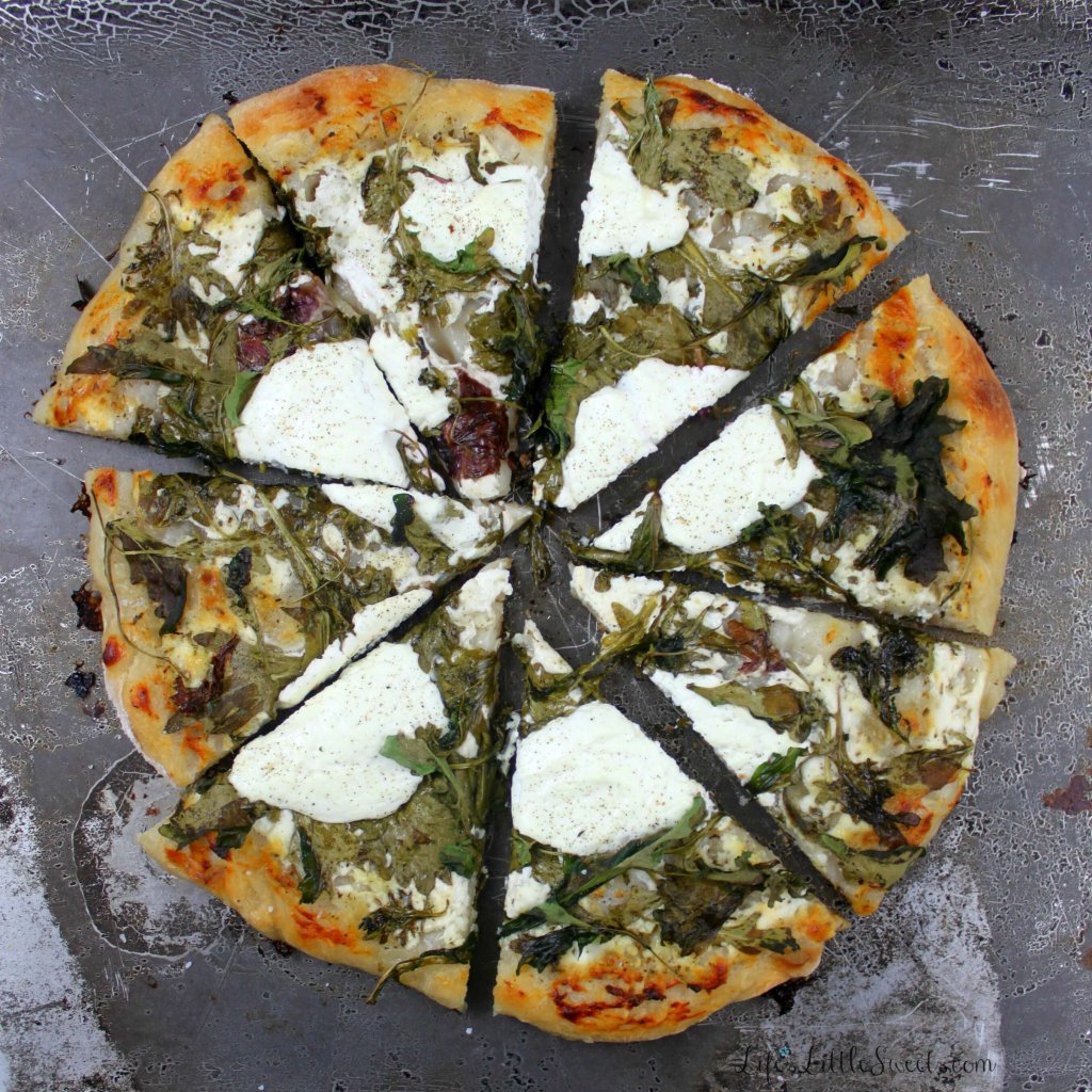 5-Ingredient White Pizza overhead view, sliced with greens