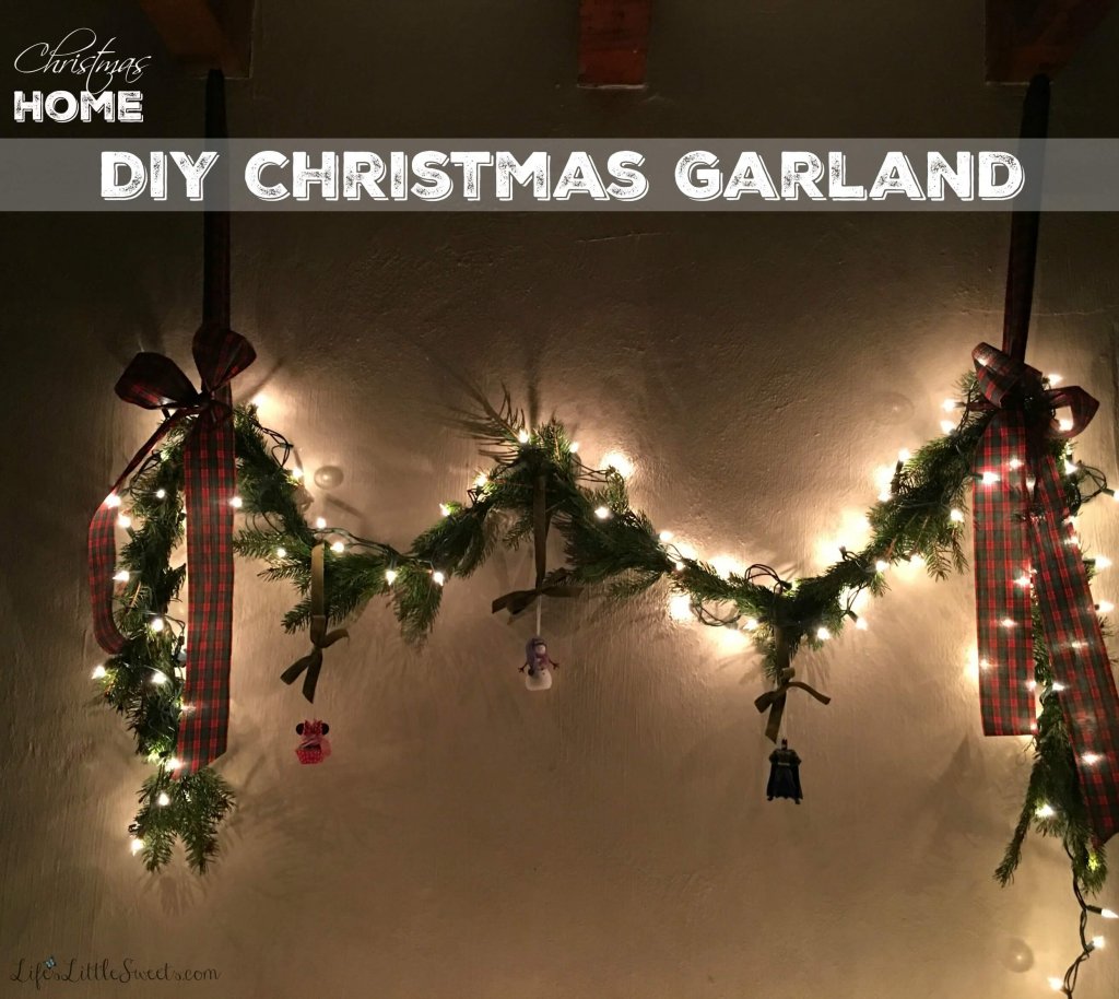 DIY Christmas Garland and Greeting Card Table on a white wall at night