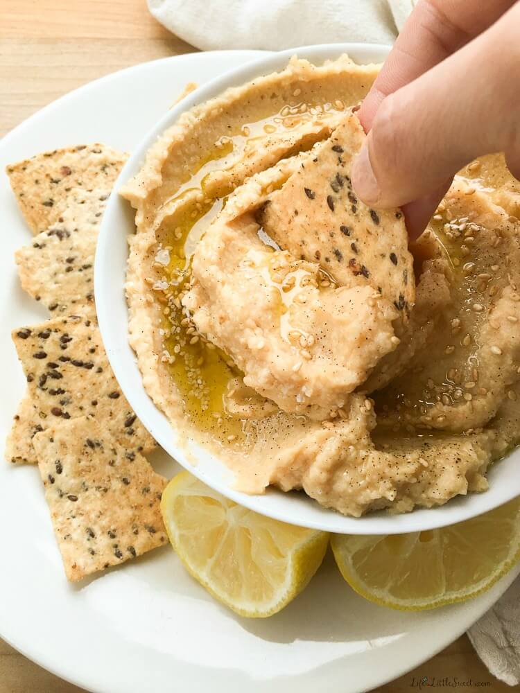 It only takes less than 7 simple ingredients and 5 minutes to make this Lemon Garlic Hummus! Enjoy with your favorite veggies, as a spread on a sandwich or with Way Better Snacks Tortilla Chips! #waybettersnacks