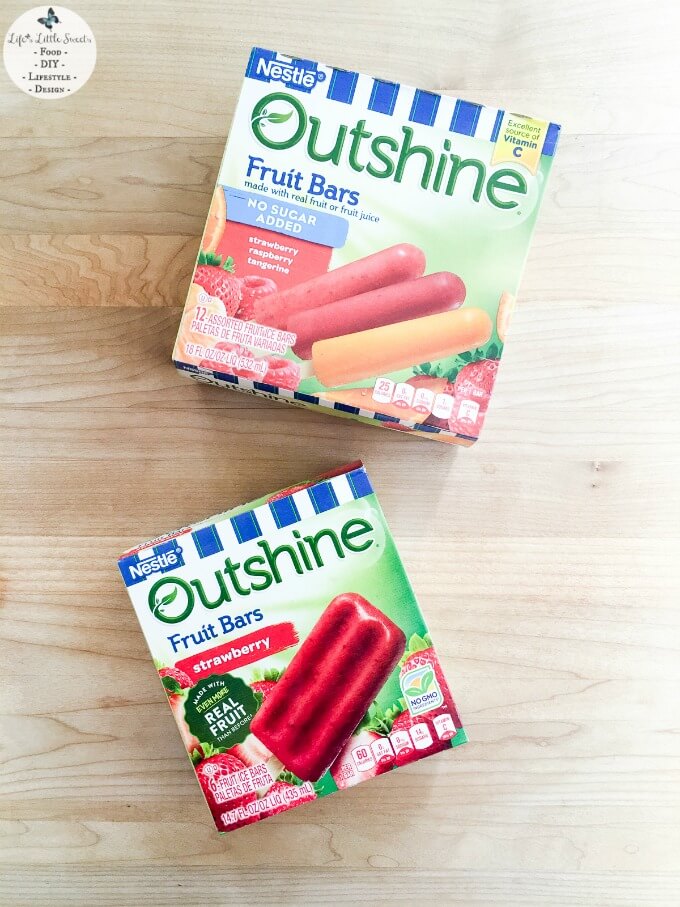 Outshine® Fruit Bars on the table - This Homemade Chocolate Shell recipe is the perfect topping for any variety of cold desserts. With only 2 ingredients and 5 minutes to make - It goes especially well with Outshine® Fruit and Veggie Bars for a lip-smacking, fruity and delicious Summer treat or for any time of year! #ad #SnackBrighter #CollectiveBias