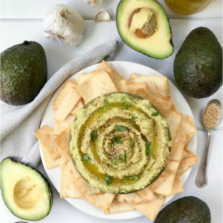 With 7 ingredients or less, this Avocado Hummus recipe is easy to whip up in minutes. Topped with sesame seeds and fresh cilantro, let this be your new favorite appetizer or party snack! Check out the entire #FoodieMamas recipe round up featuring avocados.