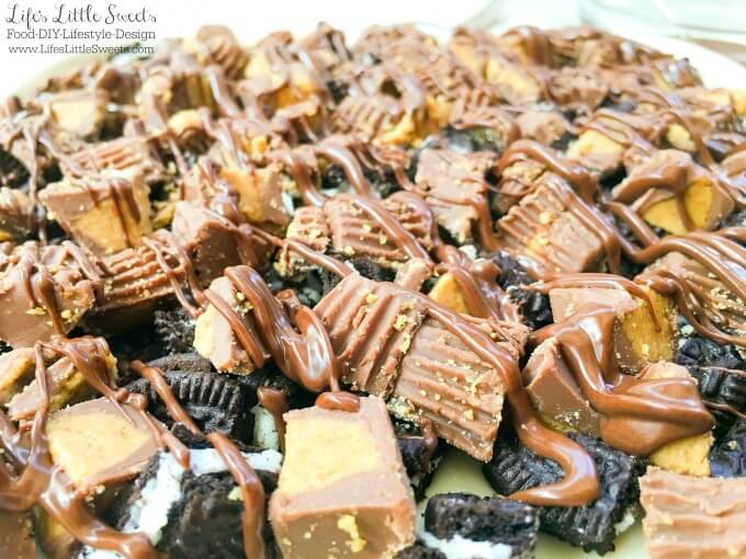 ? This One-Pan Peanut Butter Cup Oreo No Bake Cheesecake combines cheesecake with Oreo cookies and Reese's Peanut Butter Cups to create a decadent dessert! Bring this rich and creamy, no bake, layered dessert to your next gathering for everyone to enjoy.