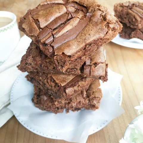 ? These Chocolate Nutella Brownies are one of my all time favorite brownie recipes with 3 kinds of chocolate in them. They are the perfect partner to a hot mug of coffee or tea or a tall glass of milk. Cure your chocolate craving with these incredible, fudgy brownies!