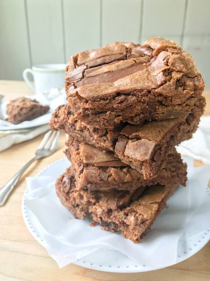 These Chocolate Nutella Brownies are one of my all-time, favorite brownie recipes with 3 kinds of chocolate in them. They are the perfect partner to a hot mug of coffee or tea or a tall glass of milk. Cure your chocolate craving with these incredible, fudgy brownies!