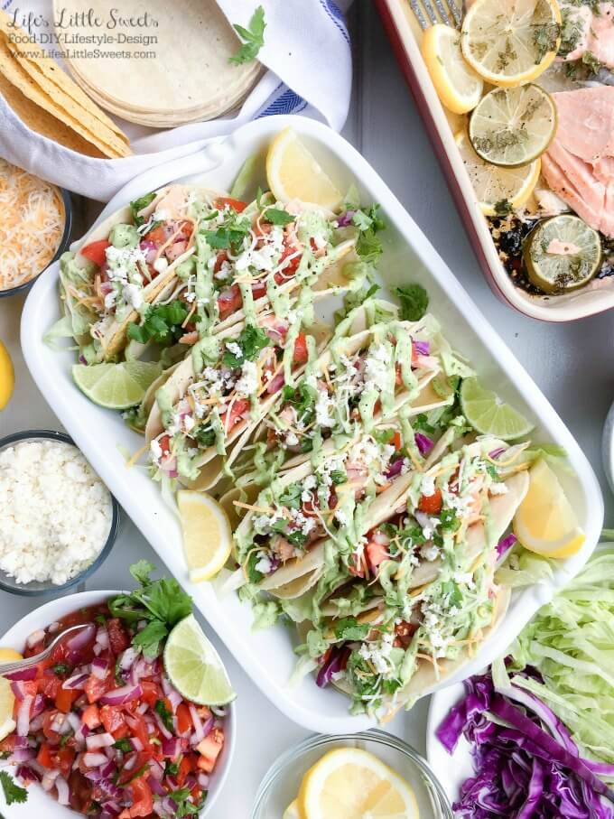 Salmon Tacos with Fresh Salsa and Avocado Sauce - These Salmon Tacos have homemade fresh salsa and a cilantro avocado sauce which will thrill your taste buds. This delicious and satisfying recipe is perfect for game day or a family dinner! #taco #avocadosauce #salsa #citrus #lemon #salmon #tortillas #cheese #lettuce #cabbage