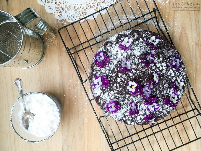 This Single Layer Chocolate Cake with Edible Flowers is a pretty and simple chocolate cake that can be whipped up when you have the need or craving for chocolate cake. No need for frosting for this elegant cake as it is decorated with confectioner's sugar and edible flowers.