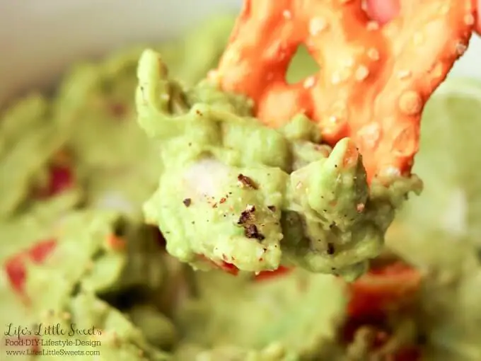 A yummy bite | This Easy Guacamole is fresh and a perfect recipe for Spring and Summer. A simple recipe with red onions, fresh chopped tomatoes and a spritz of lime, enjoy it for any gathering, game day or a quick snack for yourself!