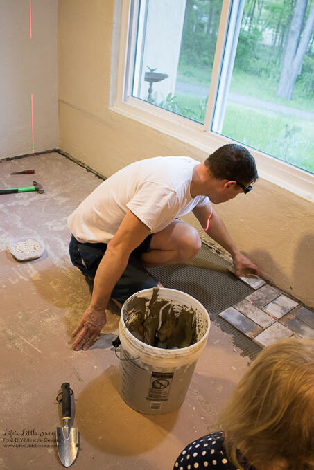 6. Our daughter watching Eric tile. | Kitchen Renovation New Tile Floor – Check out the latest from the Life’s Little Sweets home kitchen renovation being our tile floor odyssey this past week (and other updates with 45 photos!)