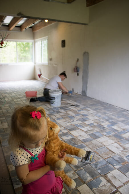 23. Our daughter inspects the tile and we gave her the position of 