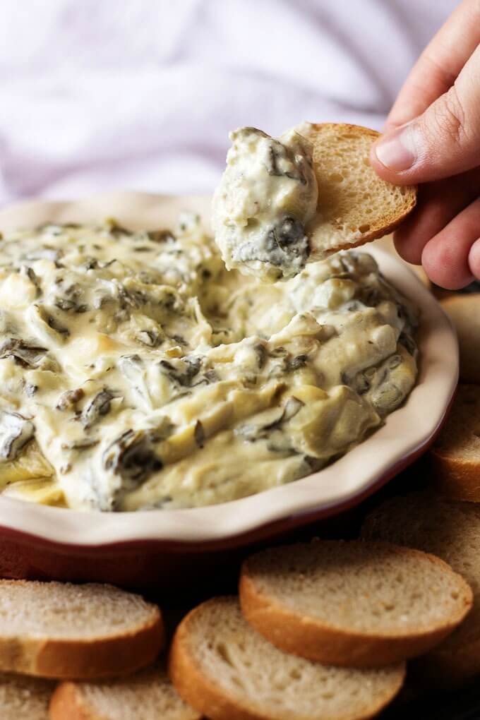 Simple Spectacular Spinach Artichoke Dip - Try our simple spectacular spinach artichoke dip made with three kinds of cheese. It's cheesy, warm, and delicious! Berly's Kitchen for www.lifeslittlesweets.com