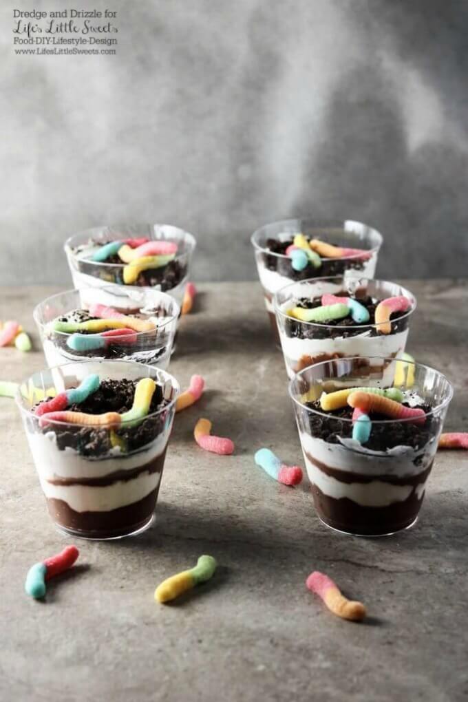 A group of Dirt Cake Cups | Many of us have been told to not eat dirt. There are always exceptions and these Dirt Cake Cups are a fun way to break the rules. Perfect for a family-friendly get together or child's birthday party! www.lifeslittlesweets.com