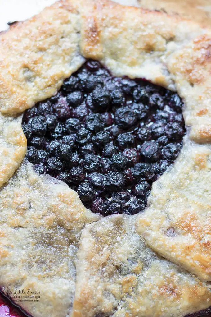 This Blueberry Galette recipe is a great dessert to showcase seasonal, fresh blueberries (you can use frozen out of season too!) encased in a homemade, flakey pie pastry dough. It goes perfectly with a large scoop of vanilla ice cream! #desserts #recipe #blueberries #sweet #fruit #berries #pie #galette #blueberrygalette