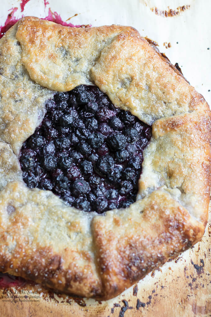 This Blueberry Galette recipe is a great dessert to showcase seasonal, fresh blueberries (you can use frozen out of season too!) encased in a homemade, flakey pie pastry dough. It goes perfectly with a large scoop of vanilla ice cream! #desserts #recipe #blueberries #sweet #fruit #berries #pie #galette #blueberrygalette