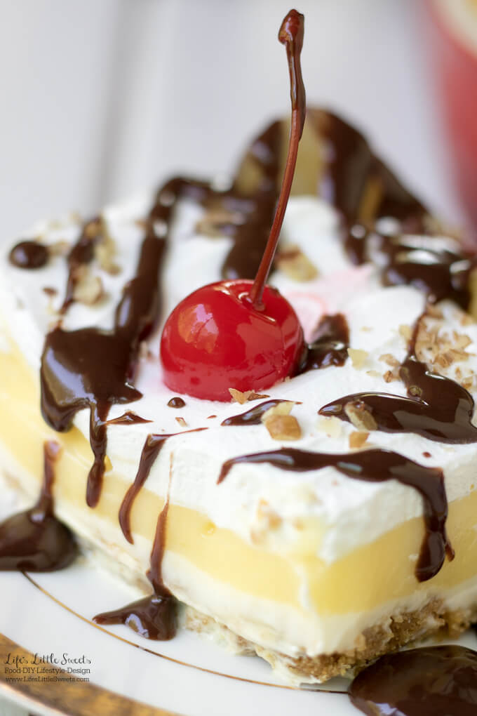 This Banana Split Lush Dessert Recipe is a Summer-y, light and sweet Banana Cream Lush dessert recipe topped with chocolate sauce, maraschino cherries and pineapple. Enjoy this delightful dessert at any Summer holiday, potluck or BBQ! (12 slices)