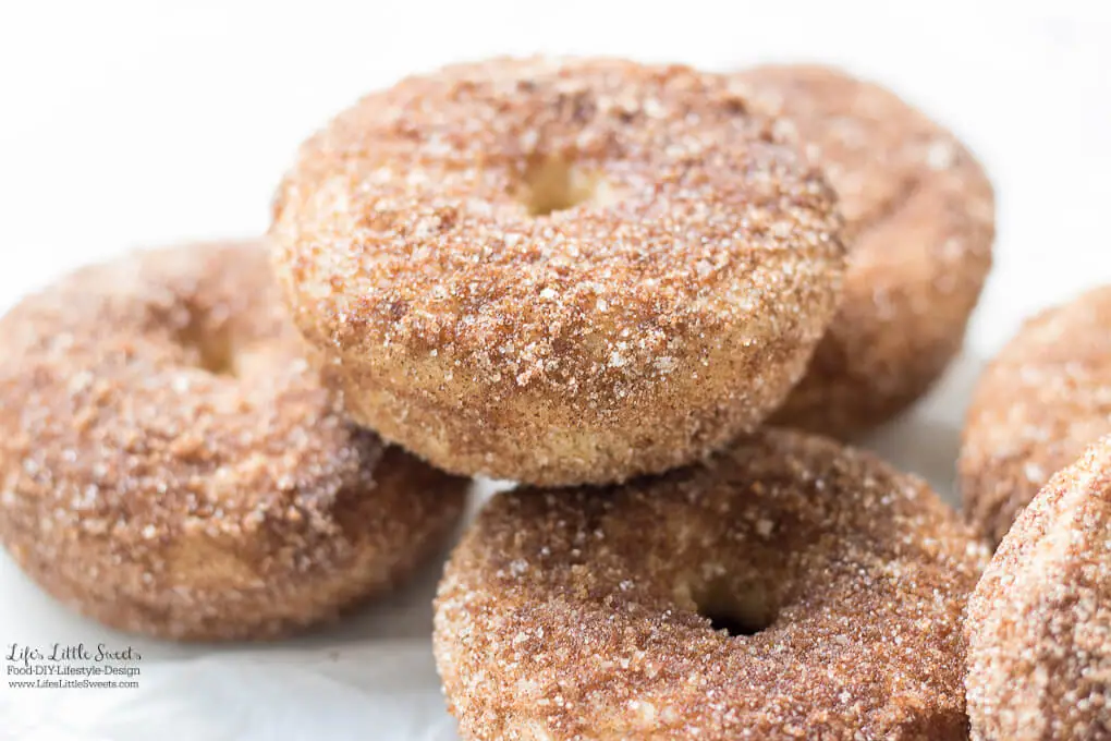 Baked Apple Cider Donuts are a delicious way to enjoy Fall. Infused with warm cinnamon and sweet apple cider, these classic donuts are also baked, not fried. #appleciderdonuts #nationaldonutday #donut #donuts #cinnamon #cinnamonsugar #applecider #doughnuts #baked #bakedappleciderdonuts