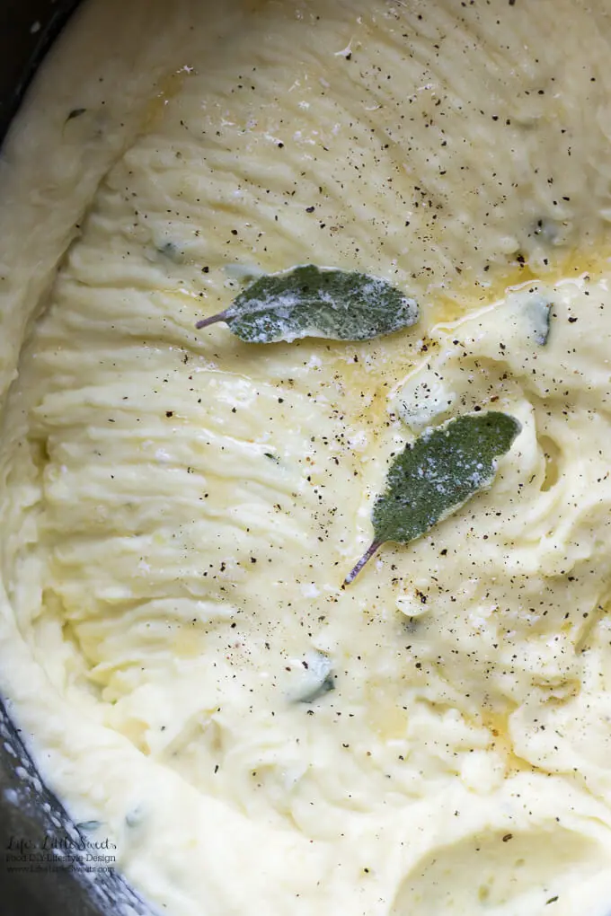 Perfect Sage Thyme Butter Whipped Potatoes are savory, full of flavor and a favorite on the Holiday table. Enjoy these creamy, butter-infused, whipped Yukon Gold potatoes at your meal! Keep them warm in a slow cooker for easy serving. #whipped #mashed #YukonGold #Thanksgiving #holiday #Christmas #slowcooker #potatoes #herb #sage #thyme #butter #creamy #cream #halfandhalf 