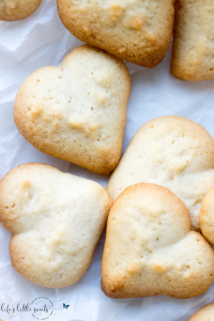This Spritz Cookie Recipe is a favorite for Christmas as it uses a cookie press and makes a large batch of cookies. These sugar cookies have a great butter flavor and can be decorated as you like or left plain. #spritz #spritzcookierecipe #cookie #cookies #heart #christmascookies 