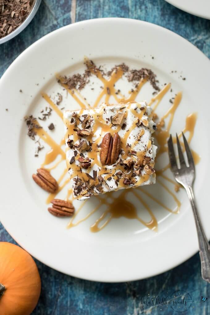 This Pumpkin Lasagna Dessert has a vanilla graham cracker crust, a sweet cream cheese layer, pumpkin spice Jello pudding, Cool Whip topping and it's topped with toasted, chopped pecans, shaved bittersweet chocolate and drizzled with caramel sauce. This no bake dessert feeds a crowd, filling a 13 x 9 inch pan; having a slice of this delicious dessert will have you craving more! #lush #dessert #lasagna #pumpkinspicepudding #toastedpecans #bittersweetchocolate #coolwhip #grahamcrackercrust #creamcheese