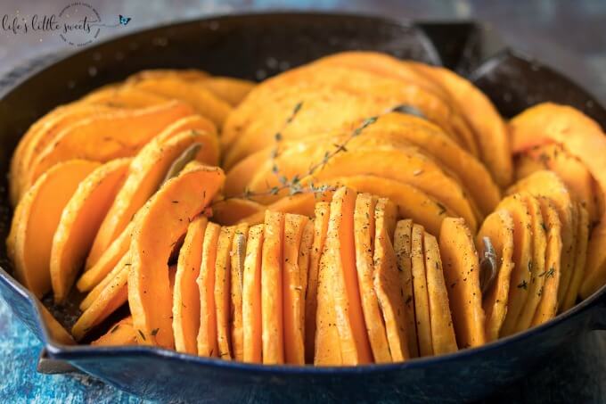 This Skillet Oven Roasted Butternut Squash is sliced thin, seasoned with herbs like thyme and sage and then baked in the oven. Enjoy this easy, tasty and beautiful way to enjoy butternut squash! (vegan, gluten-free) #butternutsquash #baked #roasted #sage #thyme #vegan #glutenfree #sliced
