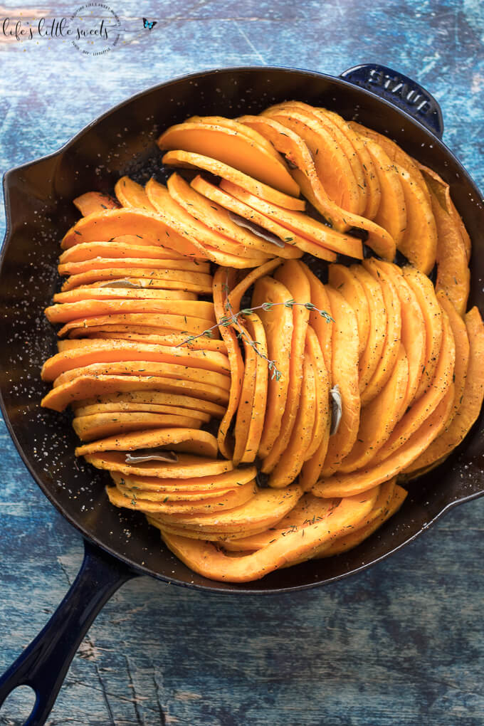 This Skillet Oven Roasted Butternut Squash is sliced thin, seasoned with herbs like thyme and sage and then baked in the oven. Enjoy this easy, tasty and beautiful way to enjoy butternut squash! (vegan, gluten-free) #butternutsquash #baked #roasted #sage #thyme #vegan #glutenfree #sliced