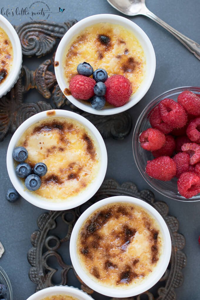 Crème Brûlée is a creamy egg and cream-based custard, infused with vanilla topped with a thin, crispy, sugar crust. Make this classic, French, 4-ingredient dessert for a decadent sweet treat. #cremebrulee #dessert #custard #fruit #berries