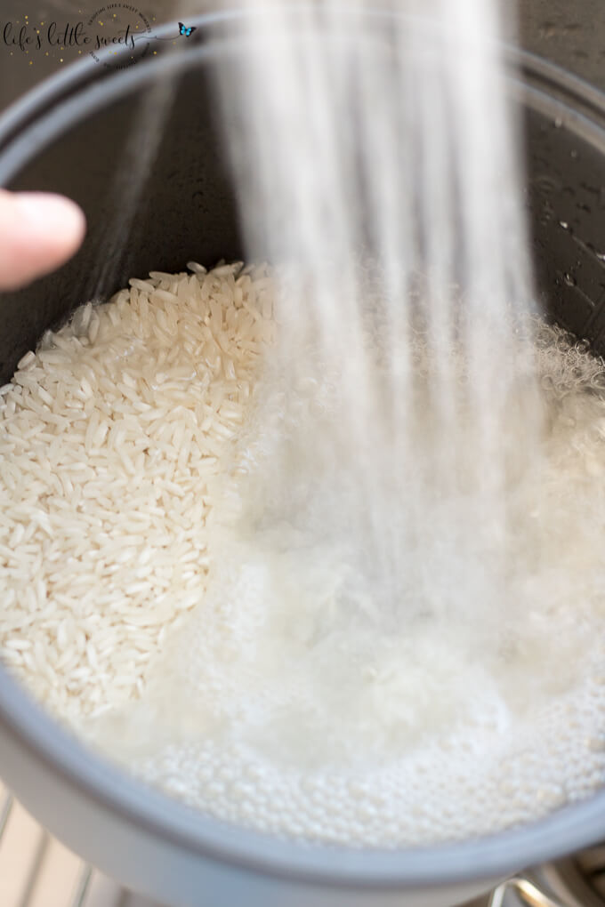 white rice being washed with water