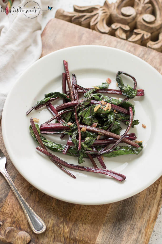 Sautéed Beet Greens are a colorful, savory and delicious addition to any meal. These greens are cooked with olive oil, garlic, salt and pepper. (1-2 servings, vegan, gluten-free) #beets #beetgreens #greens #garlic #oliveoil #Sautéed