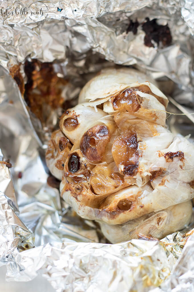 How To Roast Garlic - learn how to roast garlic! It's easy to do and the roasted garlic flavor can be spread on toast or added to salads, marinades or any meal! #roasted #garlic #oliveoil