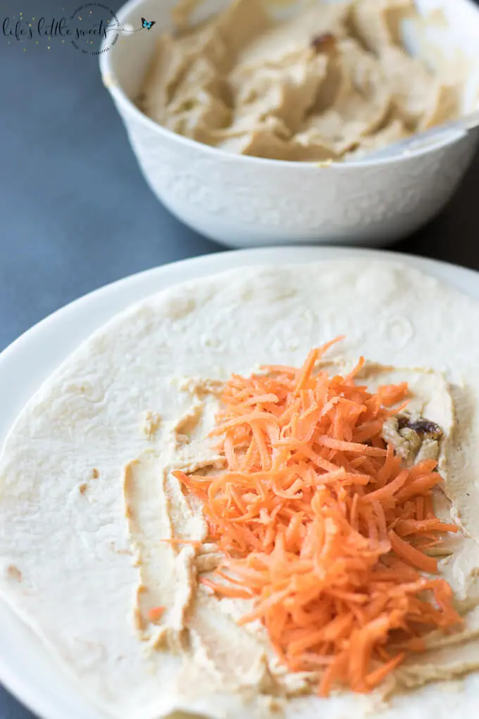 This Shredded Carrot Roasted Garlic Hummus Wrap is the perfect and simple healthy lunch. Loaded with fresh shredded carrots and roasted garlic hummus, it has both crunch and flavor. #carrots #roastedgarlic #hummus #wraps #lunch