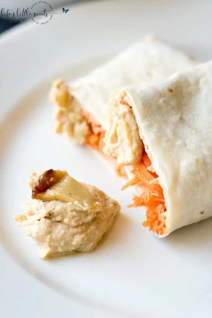 This Shredded Carrot Roasted Garlic Hummus Wrap is the perfect and simple healthy lunch. Loaded with fresh shredded carrots and roasted garlic hummus, it has both crunch and flavor. #carrots #roastedgarlic #hummus #wraps #lunch