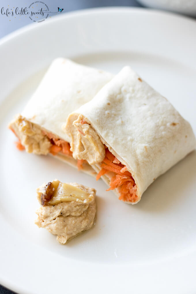 This Shredded Carrot Roasted Garlic Hummus Wrap is the perfect and simple healthy lunch. Loaded with fresh shredded carrots and roasted garlic hummus, it has both crunch and flavor. #carrots #roastedgarlic #hummus #wraps #lunch