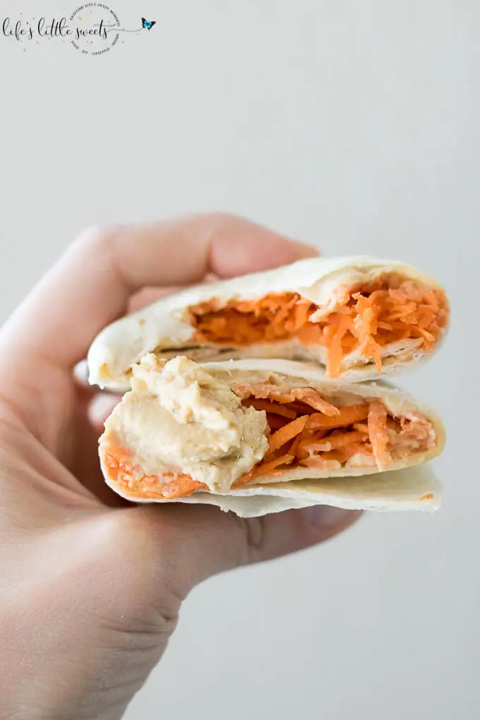 This Shredded Carrot Roasted Garlic Hummus Wrap is the perfect and simple healthy lunch. Loaded with fresh shredded carrots and roasted garlic hummus, it has both crunch and flavor. #carrots #roastedgarlic #hummus #wraps #lunch