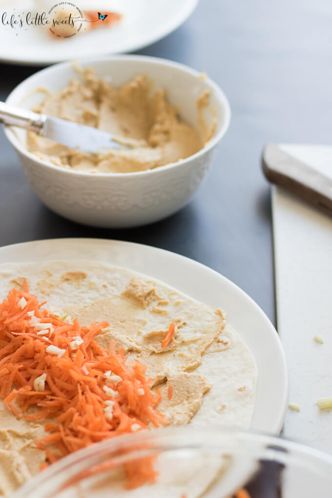 This Shredded Carrot Roasted Garlic Hummus Wrap is the perfect and simple healthy lunch. Loaded with fresh shredded carrots and roasted garlic hummus, it has both crunch and flavor. #carrots #roastedgarlic #hummus #wraps #lunch
