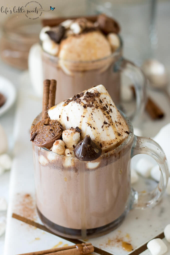 This Epic Slow Cooker Hot Chocolate is waiting for you and warms you up when you come in from the cold. It has decadent chocolate flavor, topped with marshmallows, shaved chocolate, cinnamon sticks, caramel syrup & chocolate candies. #marshmallows #hotchocolate #slowcooker #crockpot #cinnamon #cinnamonstick #Saigoncinnamon #darkchocolate #caramel #caramelsauce #homemade 