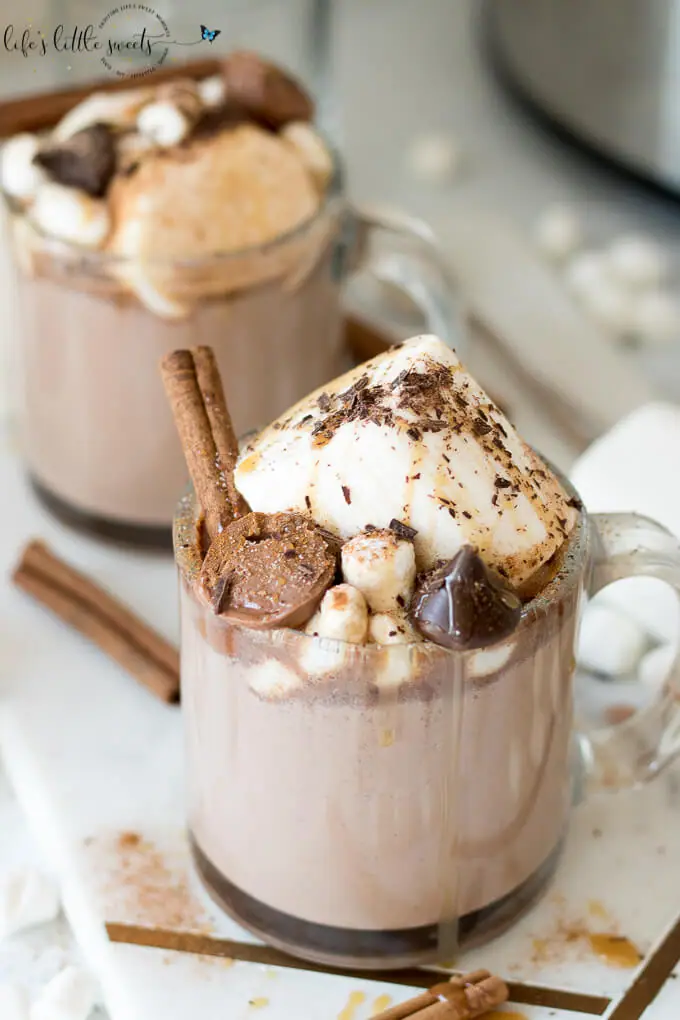 This Epic Slow Cooker Hot Chocolate is waiting for you and warms you up when you come in from the cold. It has decadent chocolate flavor, topped with marshmallows, shaved chocolate, cinnamon sticks, caramel syrup & chocolate candies. #marshmallows #hotchocolate #slowcooker #crockpot #cinnamon #cinnamonstick #Saigoncinnamon #darkchocolate #caramel #caramelsauce #homemade 