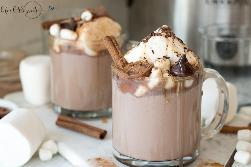 This Epic Slow Cooker Hot Chocolate is waiting for you and warms you up when you come in from the cold. It has decadent chocolate flavor, topped with marshmallows, shaved chocolate, cinnamon sticks, caramel syrup & chocolate candies. #marshmallows #hotchocolate #slowcooker #crockpot #cinnamon #cinnamonstick #Saigoncinnamon #darkchocolate #caramel #caramelsauce #homemade 