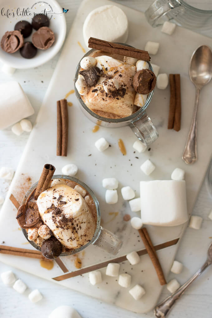 This Epic Slow Cooker Hot Chocolate is waiting for you and warms you up when you come in from the cold. It has decadent chocolate flavor, topped with marshmallows, shaved chocolate, cinnamon sticks, caramel syrup & chocolate candies. #marshmallows #hotchocolate #slowcooker #crockpot #cinnamon #cinnamonstick #Saigoncinnamon #darkchocolate #caramel #caramelsauce #homemade 