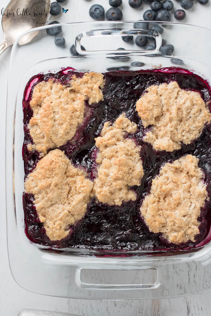 This Blueberry Cobbler has fresh, ripe blueberries with a crisp, biscuit on top. It's spiced with a secret ingredient to bring out the flavor of those blueberries. It’s wonderful on it’s own or served with vanilla ice cream or whipped cream! #blueberry #cobbler #blueberrycobbler #icecream #blueberries #sweet #dessert