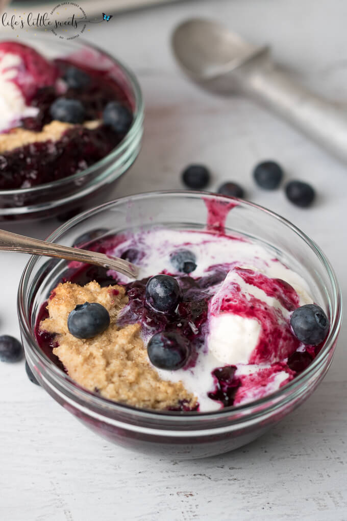 This Blueberry Cobbler has fresh, ripe blueberries with a crisp, biscuit on top. It's spiced with a secret ingredient to bring out the flavor of those blueberries. It’s wonderful on it’s own or served with vanilla ice cream or whipped cream! #blueberry #cobbler #blueberrycobbler #icecream #blueberries #sweet #dessert