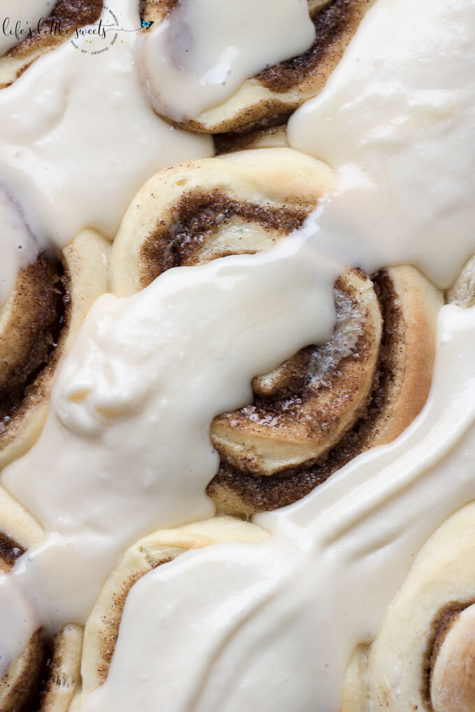 These Homemade Cinnamon Buns are a classic recipe and they are topped with cream cheese frosting. These gooey cinnamon rolls satisfy your sweet craving and they feed a crowd – perfect for holiday or weekend mornings! (makes 12 rolls) #homemade #cinnamonrolls #cinnamonbuns #recipe #classic #cinnamon #creamcheese #frosting #frosted #yeast