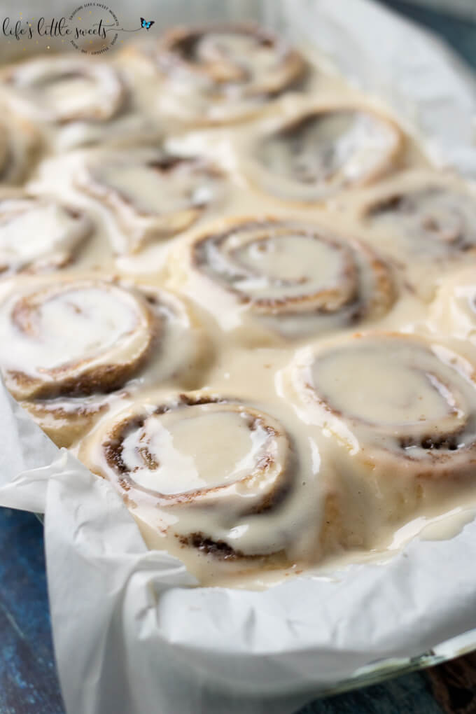 These Homemade Cinnamon Buns are a classic recipe and they are topped with cream cheese frosting. These gooey cinnamon rolls satisfy your sweet craving and they feed a crowd – perfect for holiday or weekend mornings! (makes 12 rolls) #homemade #cinnamonrolls #cinnamonbuns #recipe #classic #cinnamon #creamcheese #frosting #frosted #yeast