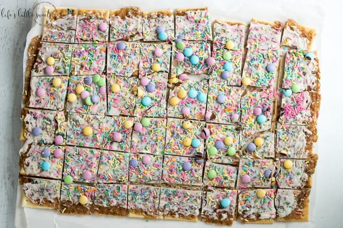 Try this Easter Saltine Toffee recipe this Spring! This classic, Saltine Toffee is an simple to make recipe, using simple pantry ingredients, white chocolate, Easter-themed, pastel sprinkles and your favorite candies. #Easter #sprinkles #candy #Saltines #whitechocolate #chocolate #candy #homemade #easy #brownsugar