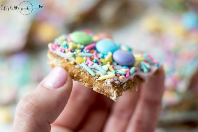 Try this Easter Saltine Toffee recipe this Spring! This classic, Saltine Toffee is an simple to make recipe, using simple pantry ingredients, white chocolate, Easter-themed, pastel sprinkles and your favorite candies. #Easter #sprinkles #candy #Saltines #whitechocolate #chocolate #candy #homemade #easy #brownsugar