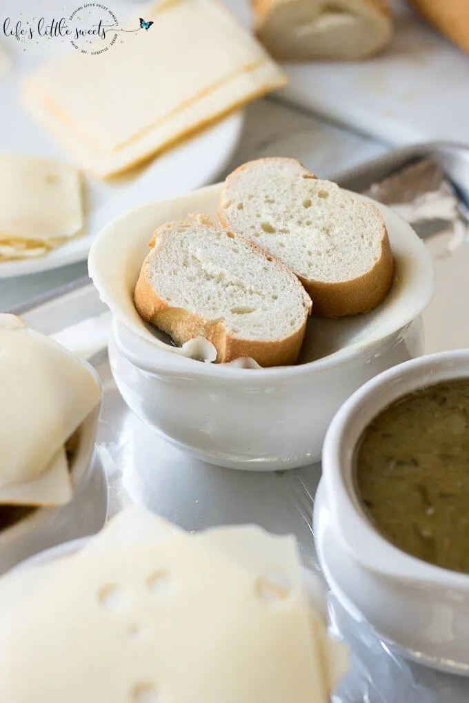 This Homemade French Onion Soup recipe has the flavors of a classic French onion soup that you would find at a restaurant, yet, it is easy to prepare in your home kitchen. Caramelized onions in a reduction of white wine and sherry with herbs of thyme and bay leaves in a clear beef broth make this soup delicious. #onions #Frenchonionsoup #cheese #recipe #Frenchbread #homemade #thyme #garlic #Muentser #Swiss