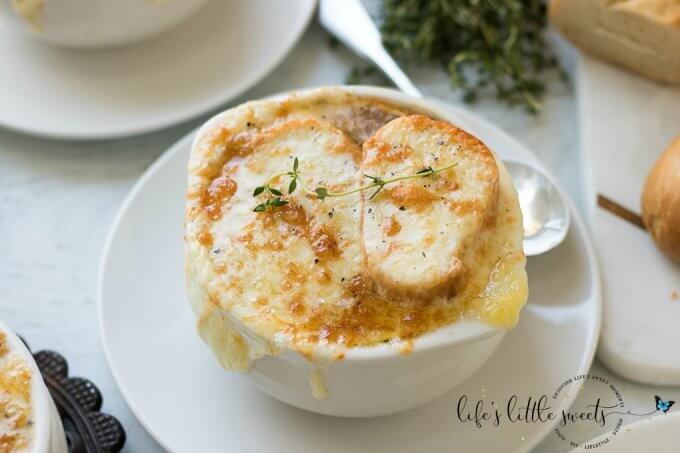 This Homemade French Onion Soup recipe has the flavors of a classic French onion soup that you would find at a restaurant, yet, it is easy to prepare in your home kitchen. Caramelized onions in a reduction of white wine and sherry with herbs of thyme and bay leaves in a clear beef broth make this soup delicious. #onions #Frenchonionsoup #cheese #recipe #Frenchbread #homemade #thyme #garlic #Muentser #Swiss