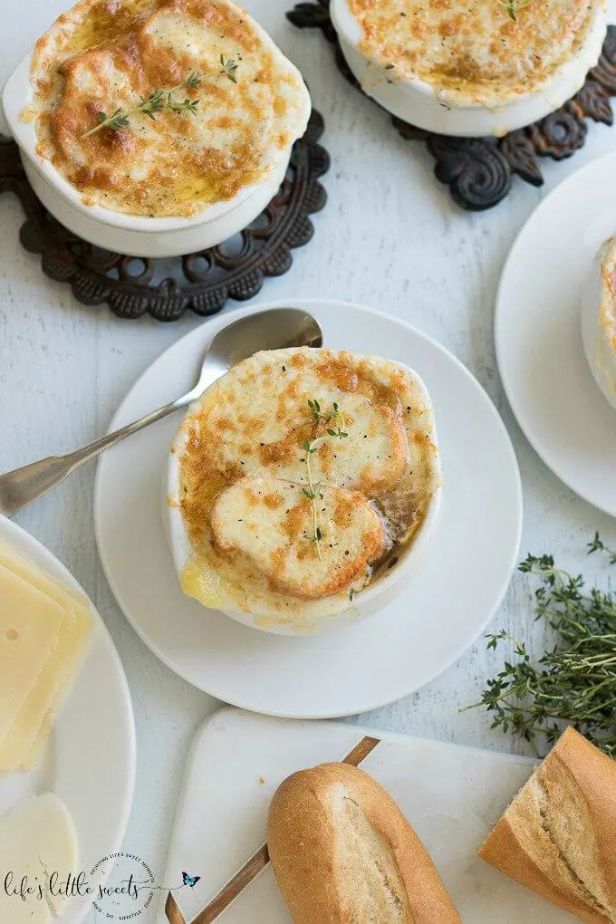 This Homemade French Onion Soup recipe has the flavors of a classic French onion soup that you would find at a restaurant, yet, it is easy to prepare in your home kitchen. Caramelized onions in a reduction of white wine and sherry with herbs of thyme and bay leaves in a clear beef broth make this soup delicious. #onions #Frenchonionsoup #cheese #recipe #Frenchbread #homemade #thyme #garlic #Muentser #Swiss